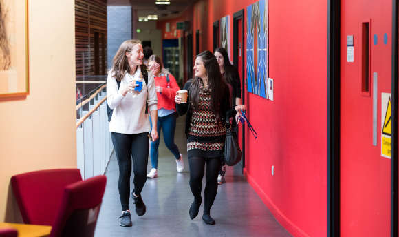 A couple of students walking down the corridor at QMU Edinburgh